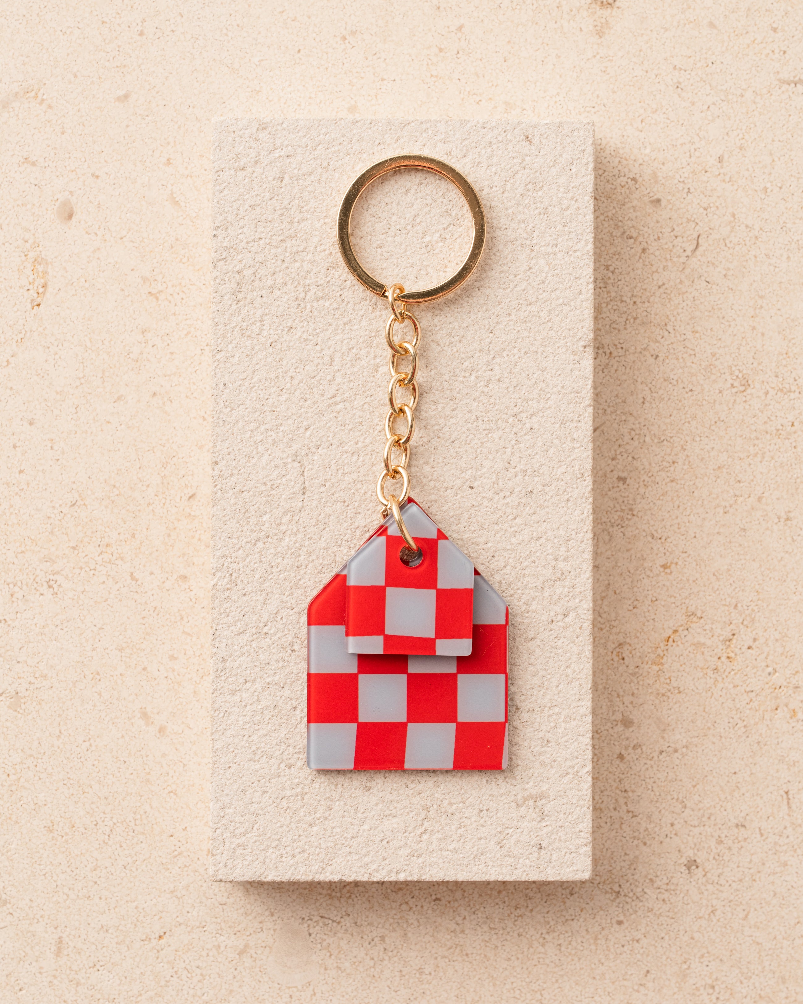 Red and gray checkered house-shaped keychain