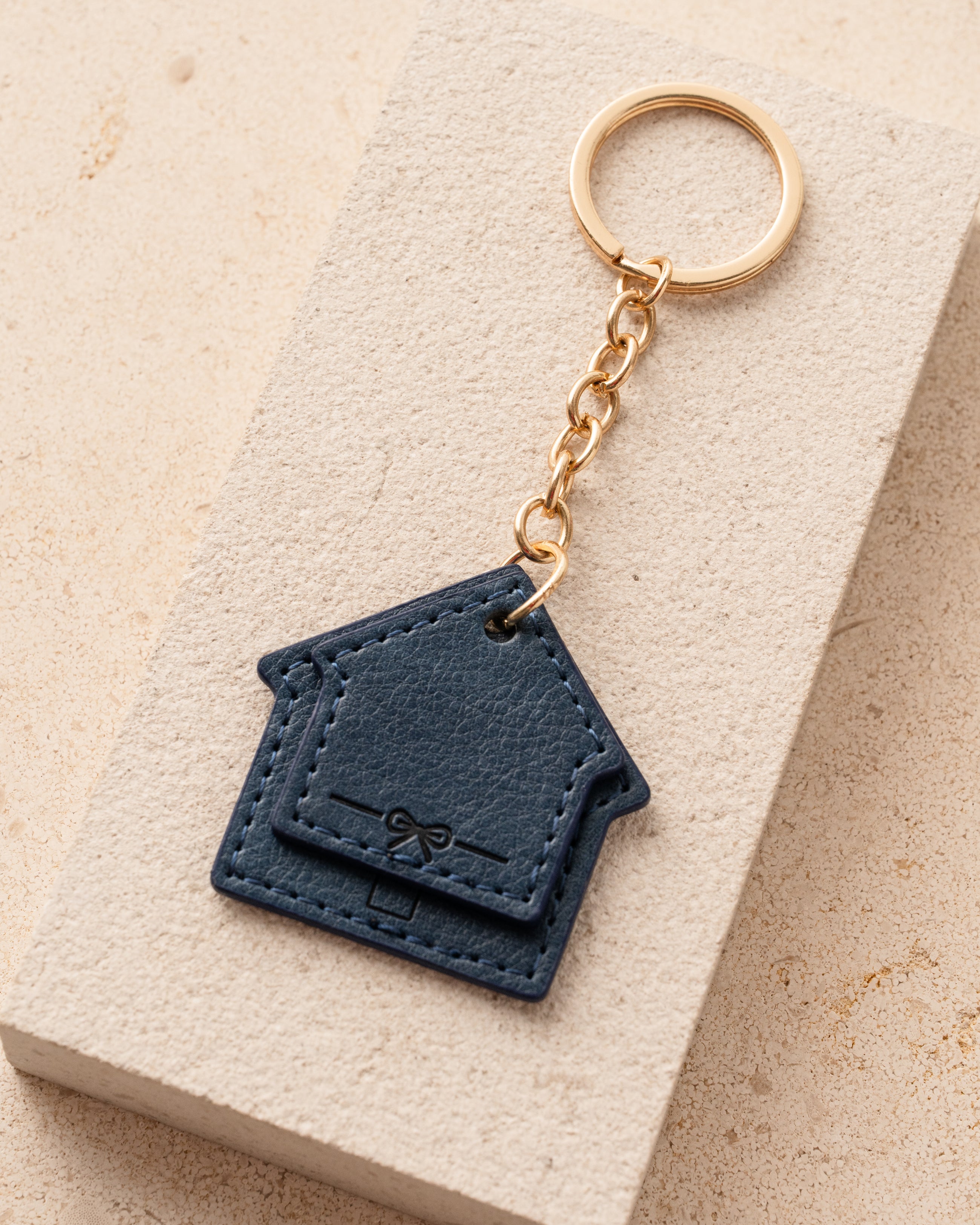 Blue leather keychain with a gold ring 