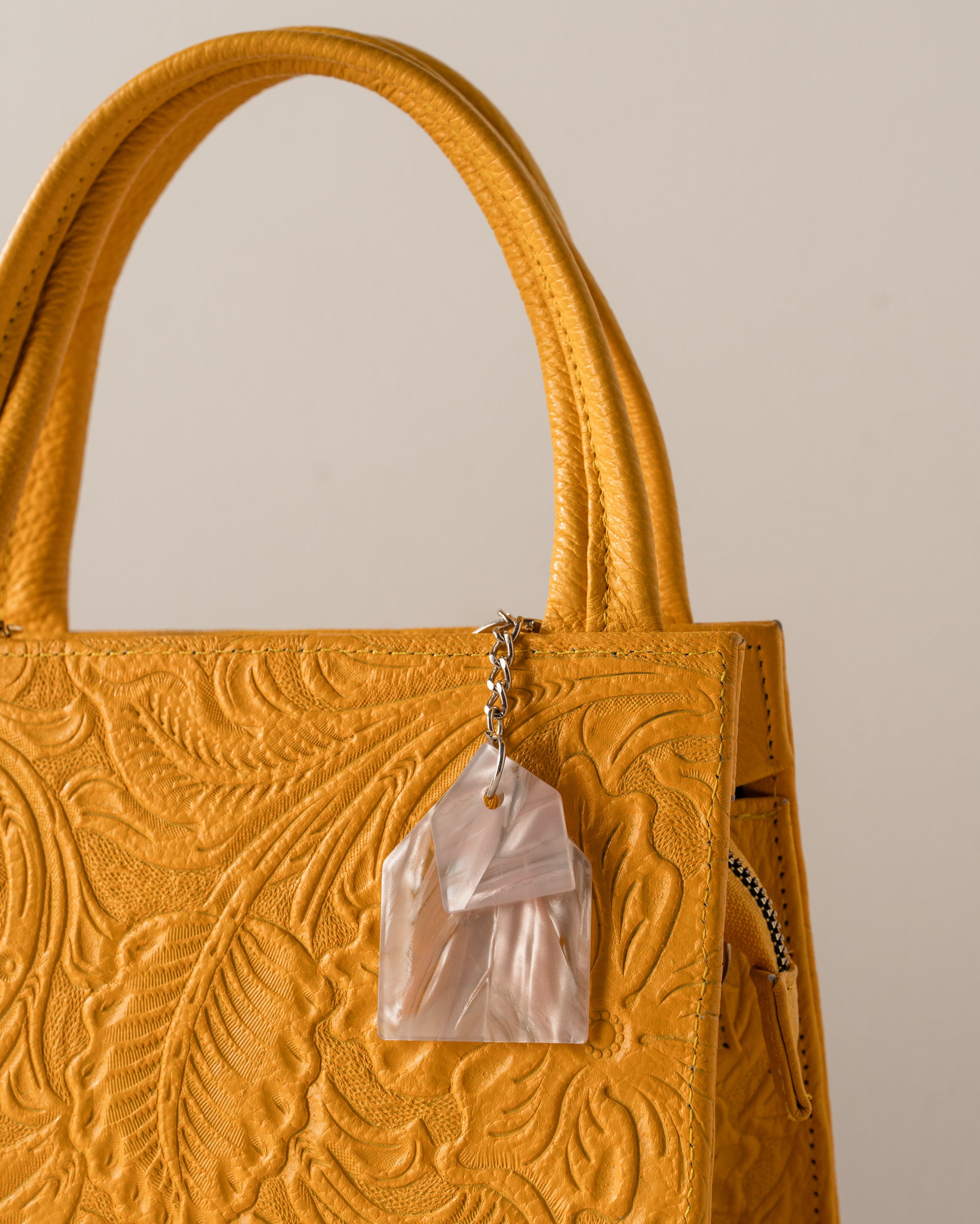 Yellow textured handbag with pearl acrylic 
