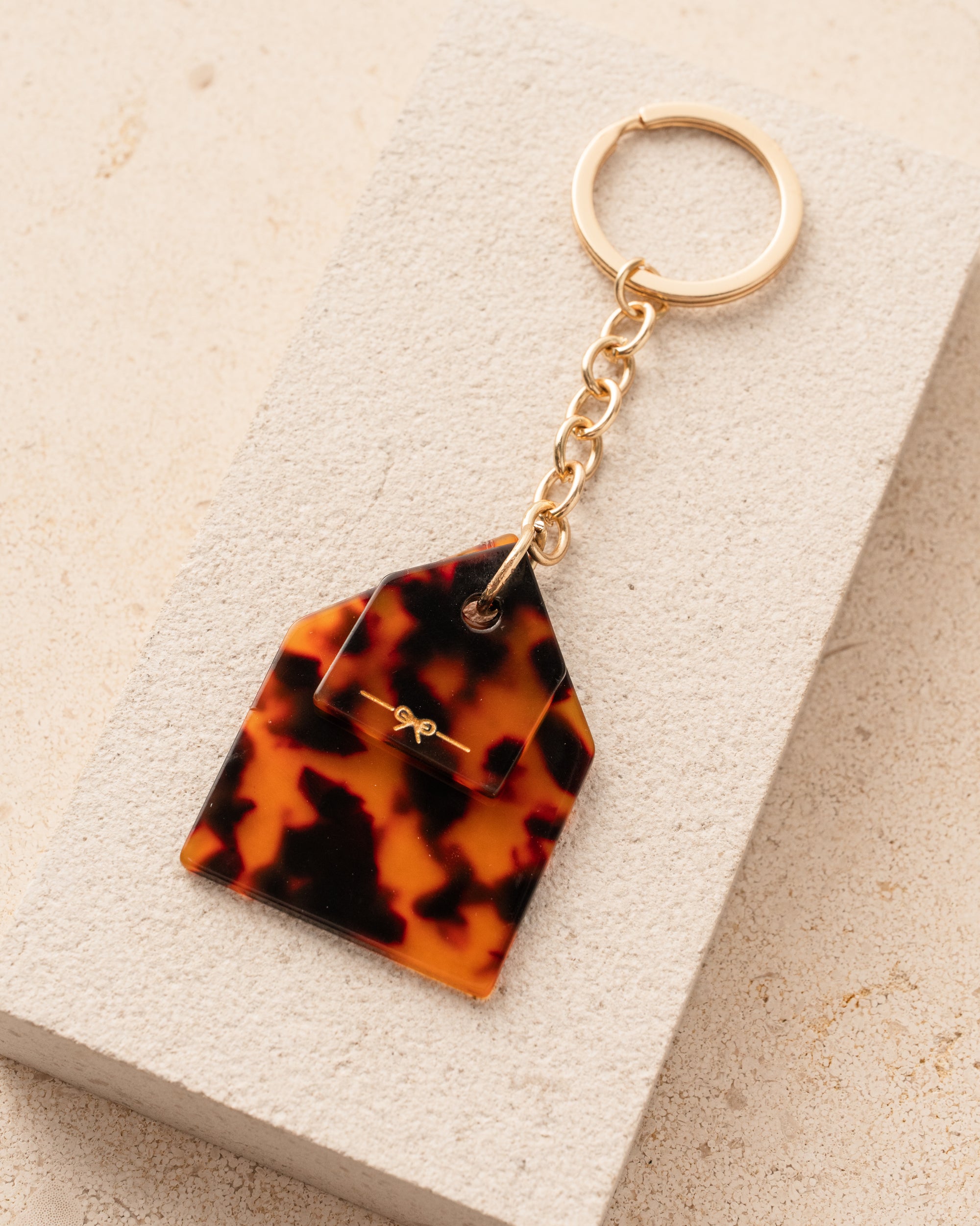 Tortoiseshell keychain on a beige surface